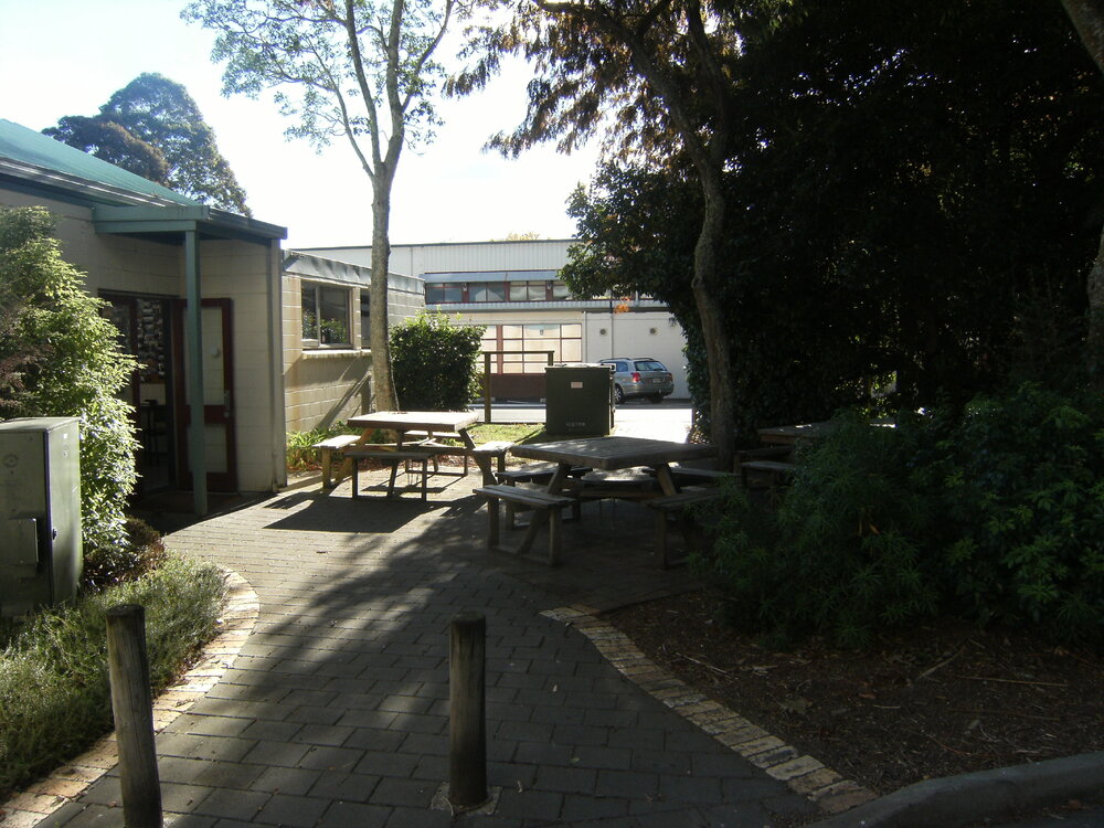 Picnic tables near groundmen's workshop.