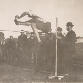 Man high jumping using scissor kick style