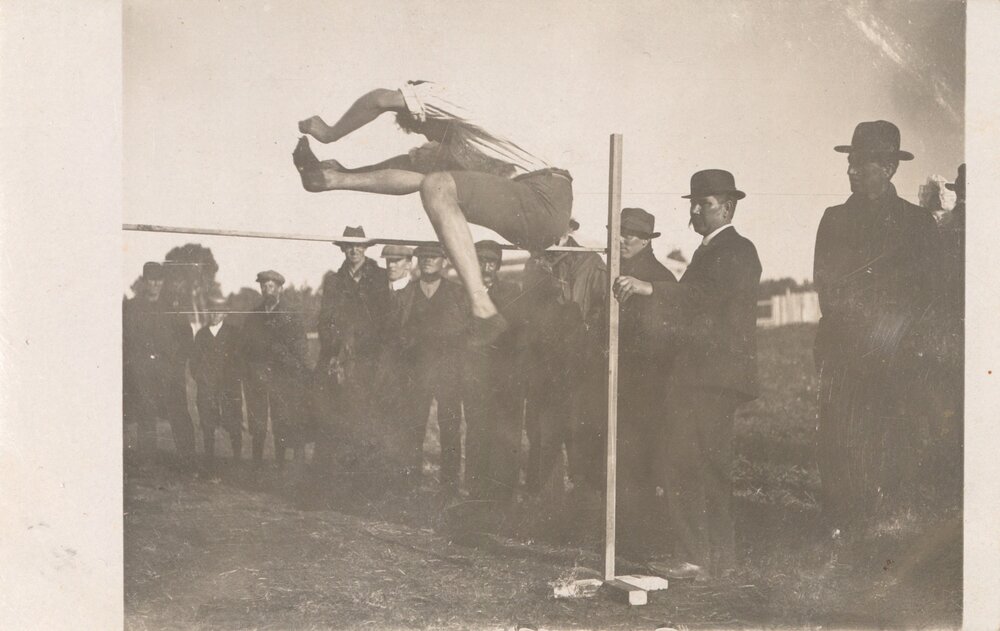 Man high jumping using scissor kick style