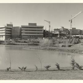Chapel Lake with Library and I Block under construction 1975