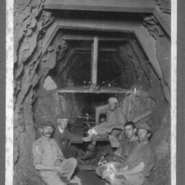 Miners sitting inside a mine 