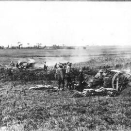 Soldiers firing a canon